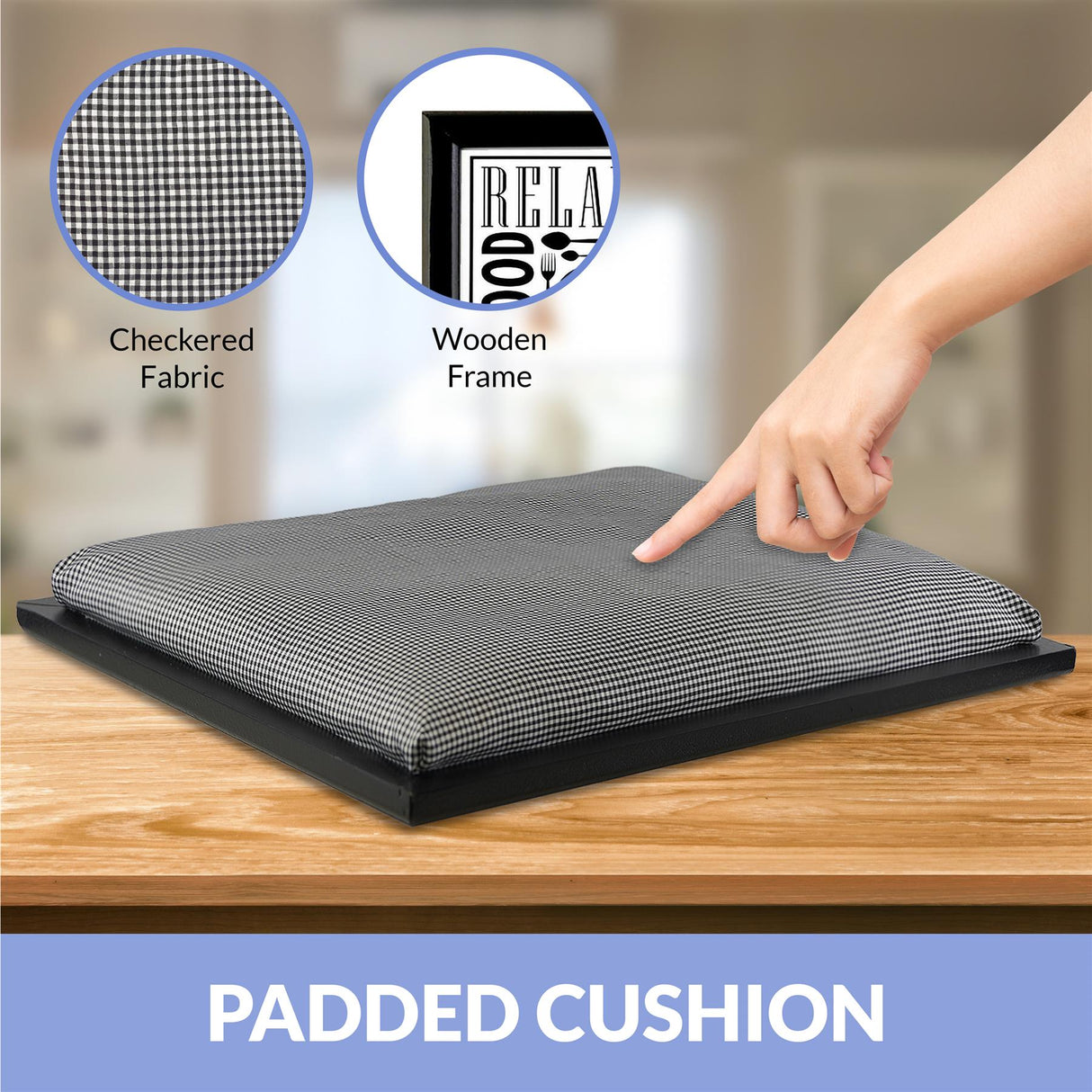A person's hand points to a cushion on a wooden table. The cushion has a checkered pattern and is placed on a black tray. - UKBuyZone
