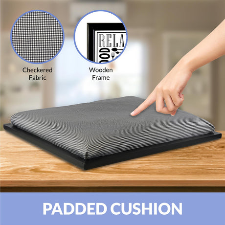 A person's hand points to a cushion on a wooden table. The cushion has a checkered pattern and is placed on a black tray. - UKBuyZone
