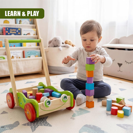Wooden baby walker, stacked colored blocks, and loose toy blocks are visible on the floor.