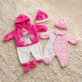 Pink and white doll outfits featuring an elephant print, a striped sleeper, and coordinating matching hats.