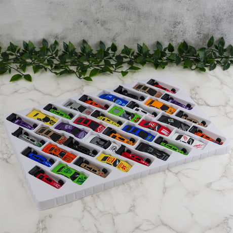 A die cast toy car set in a tray containing thirty-six colorful cars displayed on a white marble tabletop with a floral border.