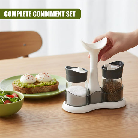 Three-piece white condiment set holding salt, pepper, and a seasoning shaker on a table.