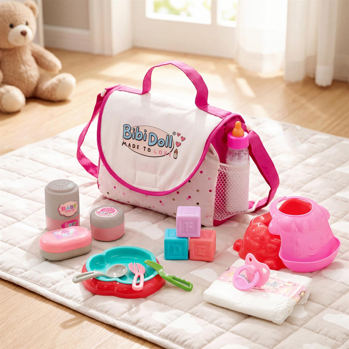 The changing bag is displayed with bottles, dishes, dispensers, and cloth accessories on a quilted mat.