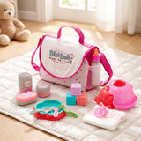 The changing bag is displayed with bottles, dishes, dispensers, and cloth accessories on a quilted mat.