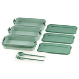 A set of three green bento box lunch trays with included spoons.