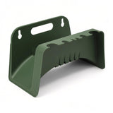 Molded green plastic bracket featuring mounting holes and horizontal slots for hose storage.