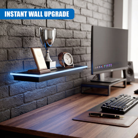 Black floating shelf with blue LED lights holding a trophy, clock and certificate on a desk against a grey brick wall