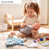 A set of doll clothes featuring blue stripes, gray koala print, and a solid knit hat.