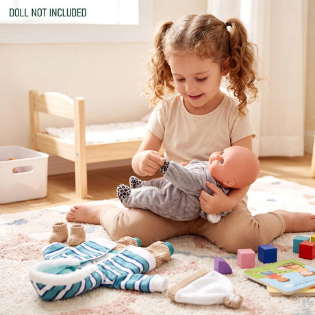 A set of doll clothes featuring blue stripes, gray koala print, and a solid knit hat.