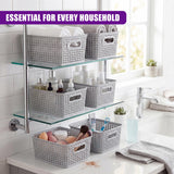 Tiered shelf unit holding six textured gray baskets filled with household toiletries and towels.