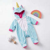 Blue unicorn hooded onesie outfit displayed alongside a cloud toy and colored rainbow arch.