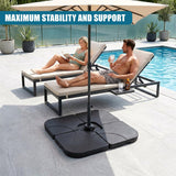 Black square base anchors the pole of an outdoor patio umbrella near a poolside lounge area.