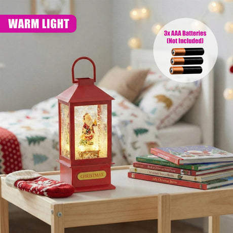 Red lighted Christmas lantern displayed with a stack of books and AAA batteries on wood.