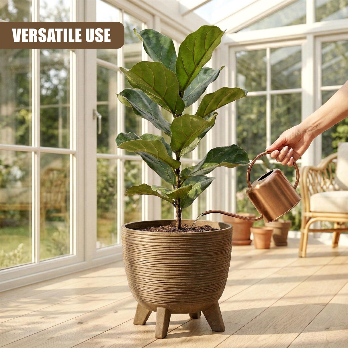 An indoor plant in a brown, legged pot receives water from a small metal watering can.