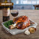 Metal roasting tray with rack, holding roasted chicken, herbs, garlic, and onion.