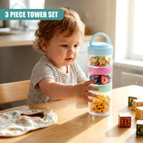 Toddler reaching toward a three-tier snack pot containing berries, grains, and vegetables.