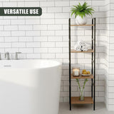 Four tiered black metal shelves display towels, soap, and greenery beside a white bathtub.
