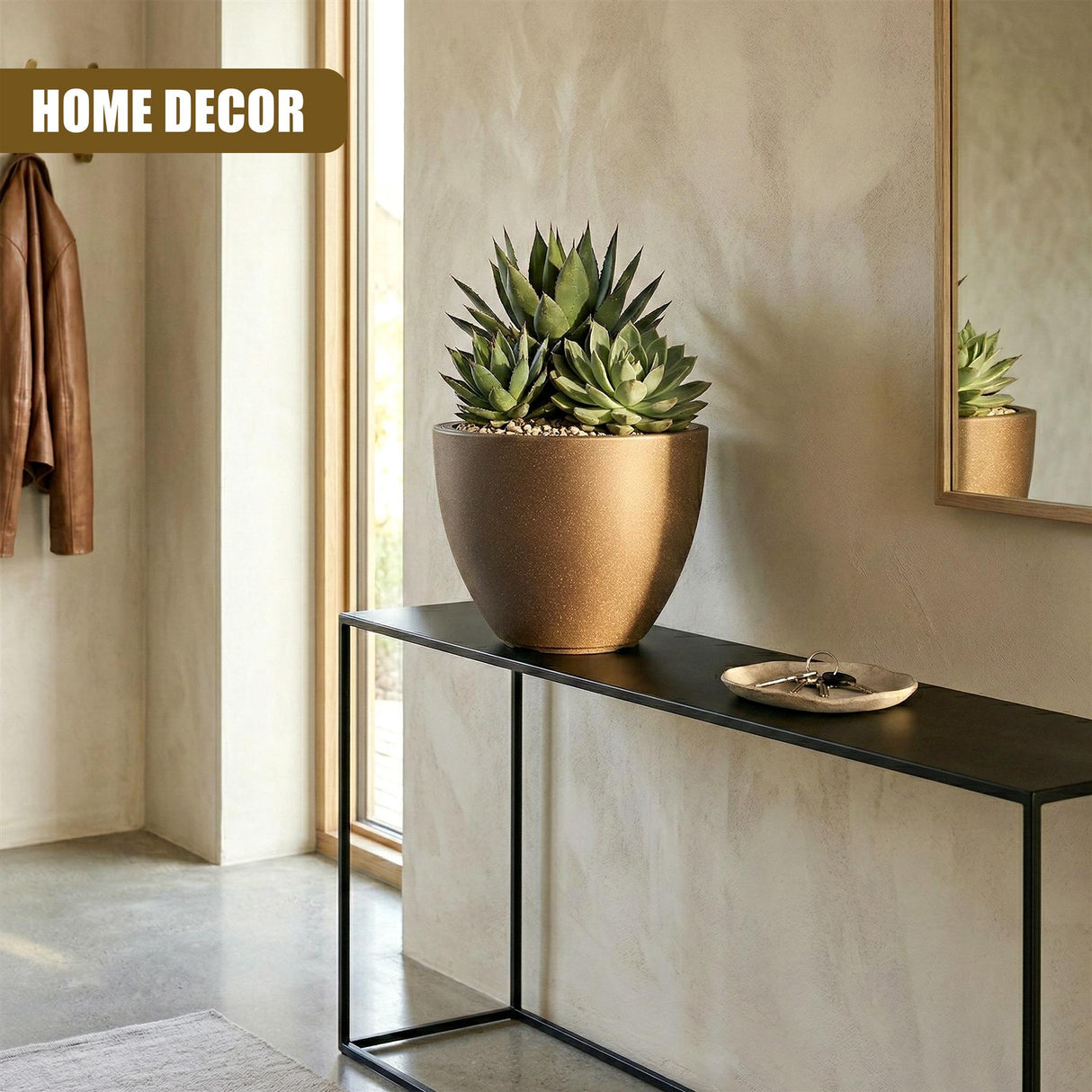 Large bronze oval pot holding succulents rests on a dark modern console table.