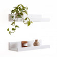 White wall hanging shelf pack of two from GEEZY displaying a plant and candle