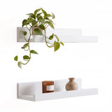 White wall hanging shelf pack of two from GEEZY displaying a plant and candle