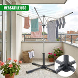 Folding metal patio drying rack structure supporting hanging laundry items on a balcony.