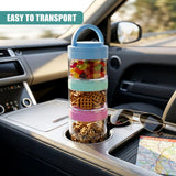 Three stackable snack pots filled with snacks sit on a car dashboard next to sunglasses and a folded map.