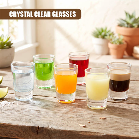 A set of six clear shot glasses filled with various liquids on a wooden surface