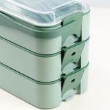 A green Geezzy Bento lunch box with three compartments.