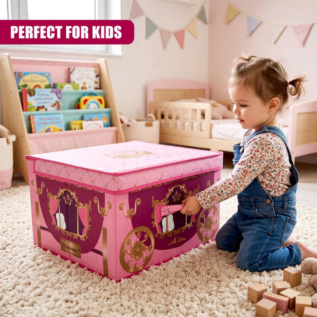 A young girl in denim overalls kneels on a rug next to a large pink carriage storage box