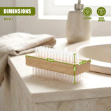Wooden brush dispenser holding multiple clear nylon nail scrubbing brushes on a counter.