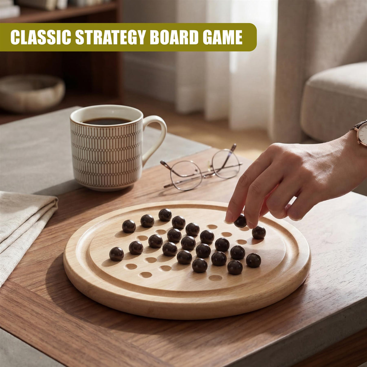 Hand placing dark game pieces on a circular wooden solitaire board for play.