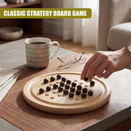 Hand placing dark game pieces on a circular wooden solitaire board for play.
