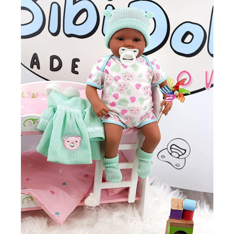 "Babydoll's pink dress and blue blanket, sitting on a pink doll bed with wooden blocks." - UKBuyZone