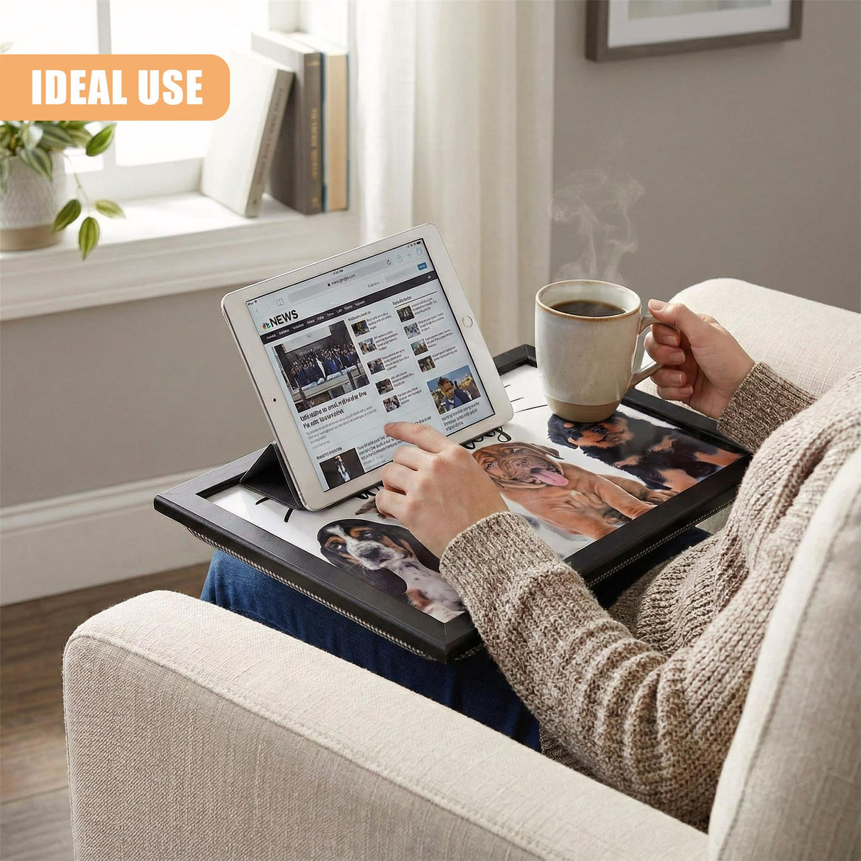 A woman sits in a cozy armchair, holding a steaming cup of coffee and using an iPad to read the news on a tablet stand on her lap. The tablet stand is a versatile, adjustable, and compact device that allows her to read, work, or watch videos in comfort. - UKBuyZone