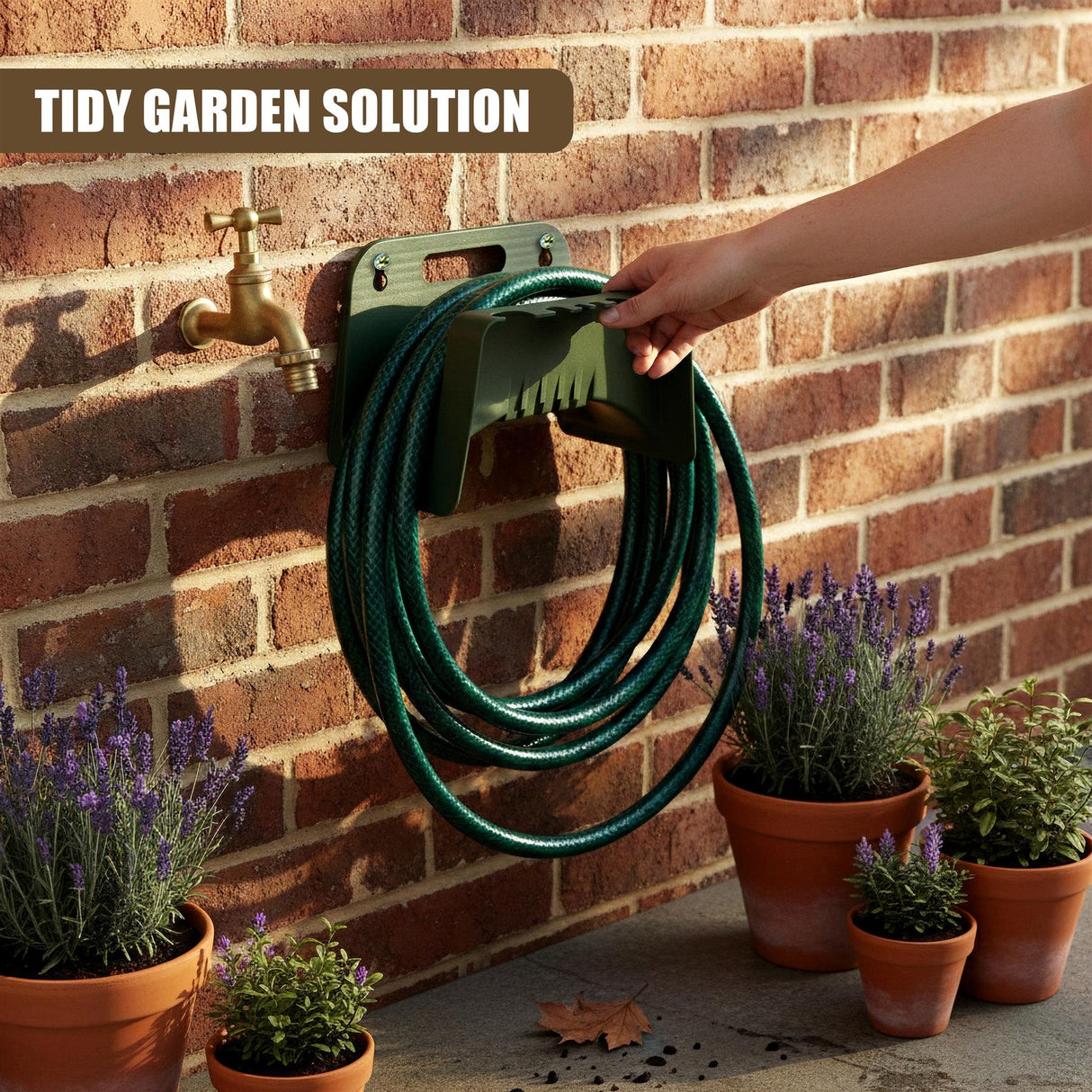 Dark green hose coiled on a plastic holder mounted on a red brick wall near potted plants.