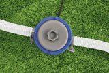 The image displays a pool pump on a surface with grass in the background.