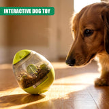 Yellow treat dispensing toy filled with kibble sits on wood floor near a brown dog.