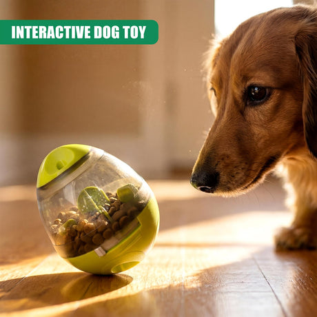 Yellow treat dispensing toy filled with kibble sits on wood floor near a brown dog.