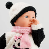 Small baby doll with black panda hoodie and scarf.