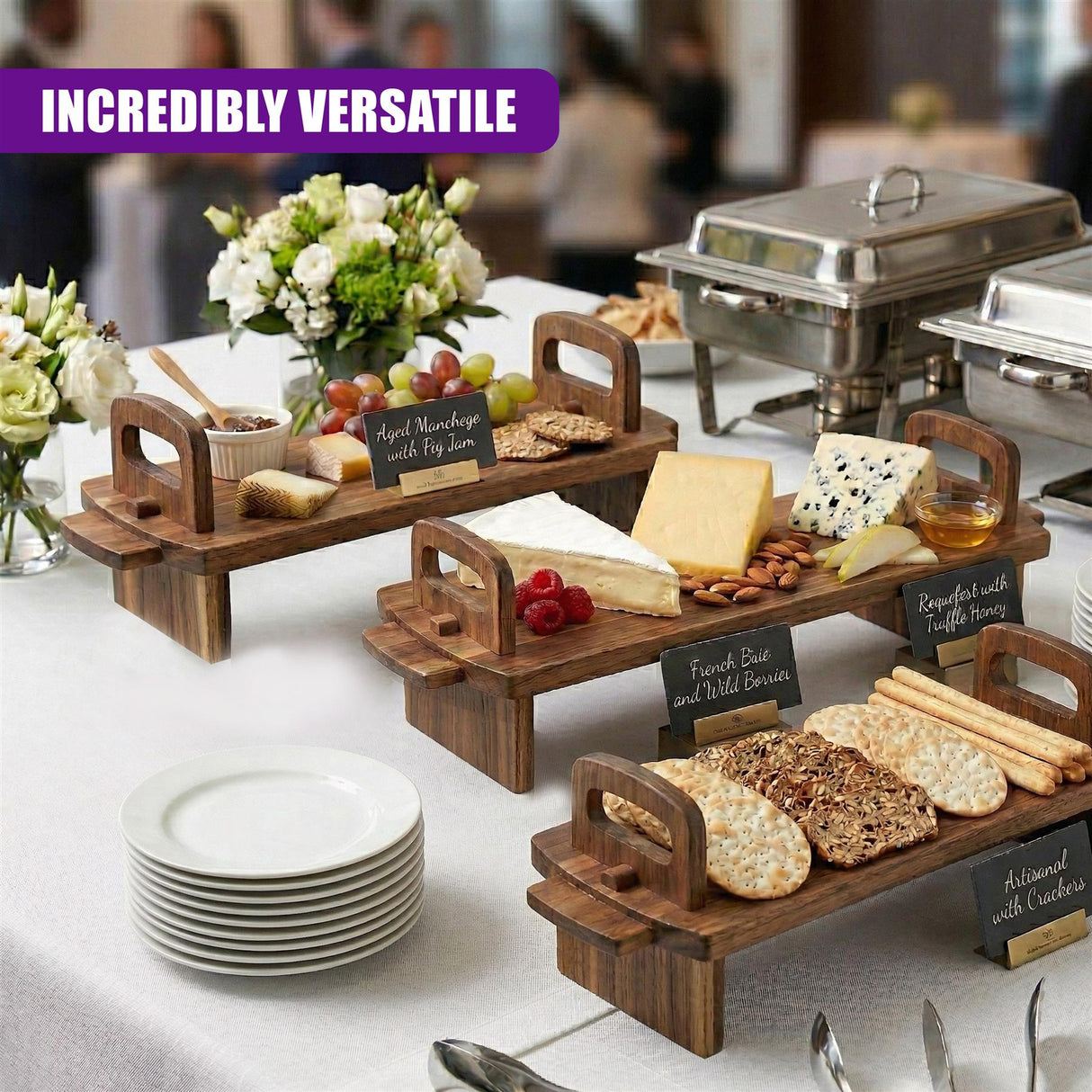 A collection of wooden serving platters displays cheeses, crackers, bread, grapes, and various fruit snacks.