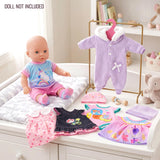 The image displays six doll outfits, including pink dresses and a lavender cardigan, arranged on a white dresser.