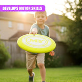 Young boy in shorts holds yellow frisbee outdoors in natural light.