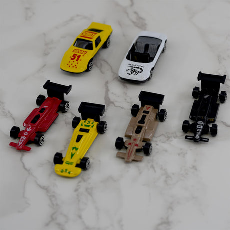 A collection of diecast race cars displayed on a marble table.