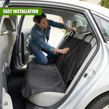 "Person installing car seat cover, showcasing use with trunk open, emphasizing protection and easy installation." - UKBuyZone