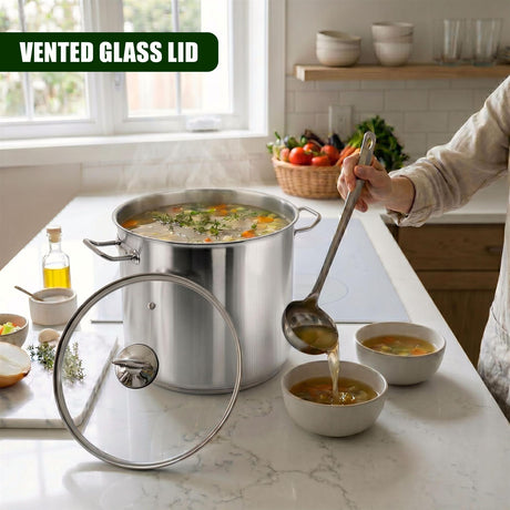 Stainless steel stock pot with a glass lid, steam rising, and soup being ladled into white bowls.