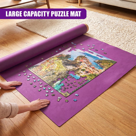 Purple puzzle mat featuring a landscape image, loose puzzle pieces, and a rolled section on a wood floor.