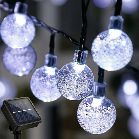 Solar powered string lights with crystal ball glass bulbs and wire cords.