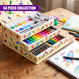 Open art set box holding watercolor palette, colored pencils, and crayons on a wooden surface.