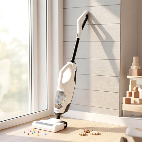 White stick vacuum cleaner rests on a wooden floor near scattered colorful pieces and wooden blocks.