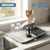 A kitchen dish drying rack holds glassware, utensils, and a canister on a countertop.